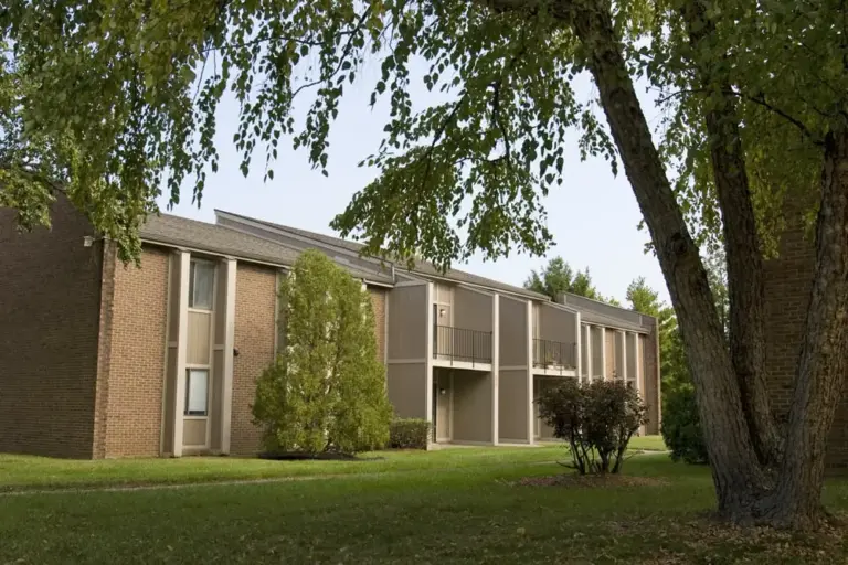 Apartment complex in Louisville, Kentucky before exterior painting showing faded siding and original trim prior to renovation.