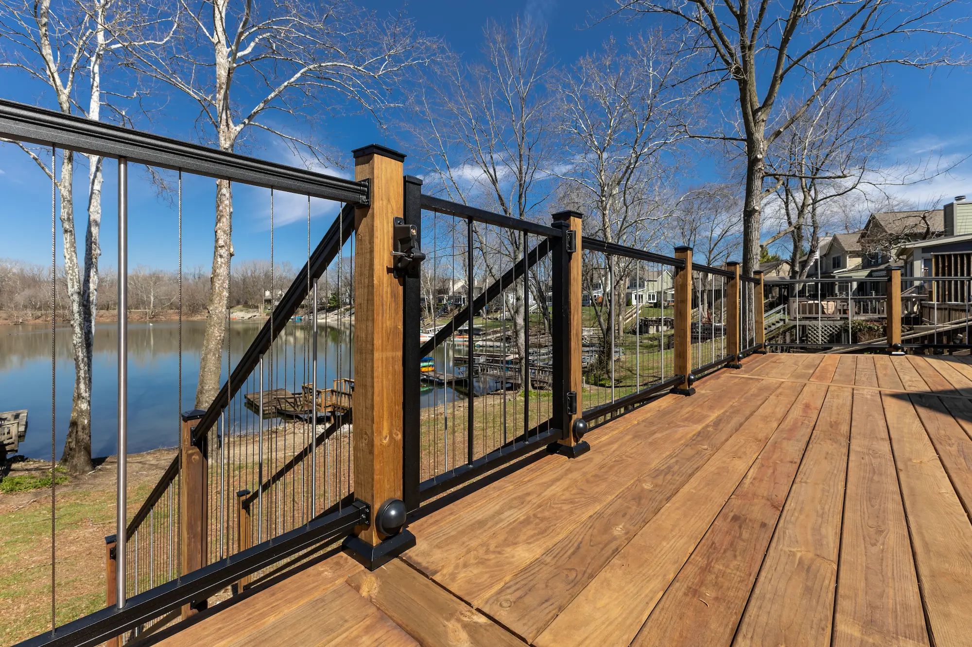 Modern wood deck with black cable railing and lake view in Indianapolis IN