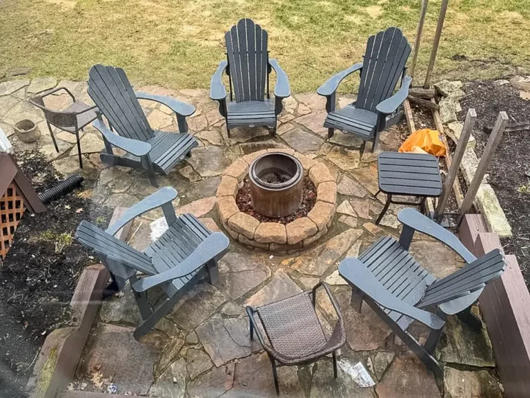 Before patio renovation showing outdated stone patio and fire pit area at a home in Carmel, Indiana