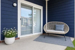 Updated apartment patio with blue siding, painted trim, and seating area at Crestview Apartments in Louisville, Kentucky