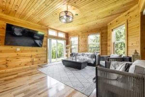 Interior of custom sunroom addition featuring cedar walls, large windows, and comfortable gathering space in Carmel, Indiana
