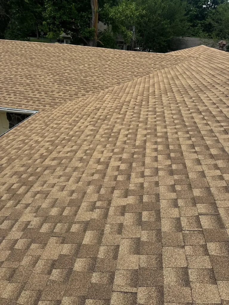 Completed residential roof replacement with new brown architectural shingles