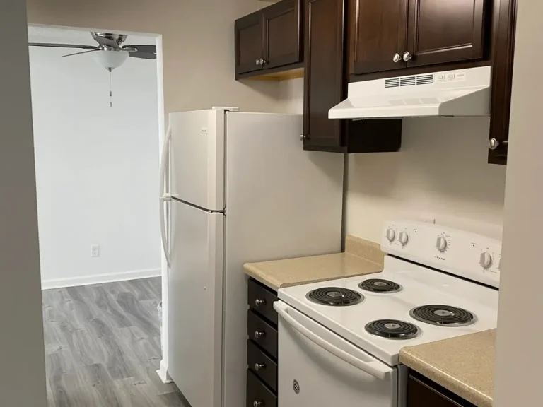 Completed fire and smoke damage restoration in Indianapolis apartment kitchen with new cabinets, appliances, flooring, and fresh finishes.