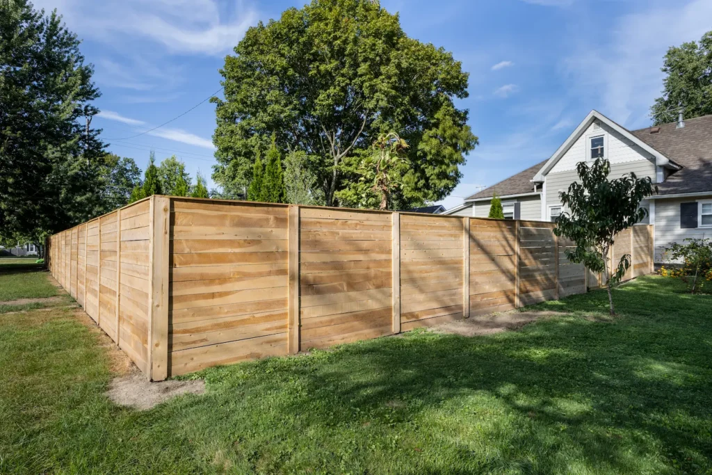 New horizontal wood privacy fence enclosing a residential backyard
