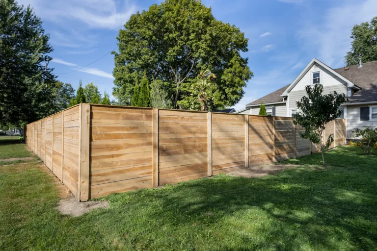New horizontal wood privacy fence enclosing a residential backyard