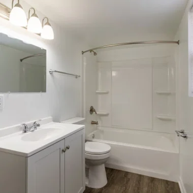 Bathroom renovation with updated tub-shower combo, fresh white finishes, and new vanity in Indiana.