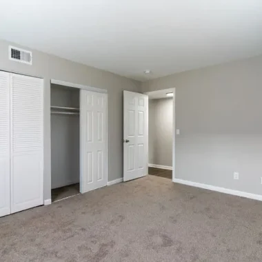 Updated bedroom with new carpet, fresh paint, and renovated closet space by AY Remodeling & Restoration.