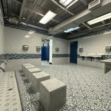 Commercial renovation featuring custom tile work, new sinks, and updated restroom design in Carmel, Indiana.