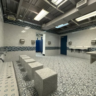 Commercial renovation featuring custom tile work, new sinks, and updated restroom design in Carmel, Indiana.