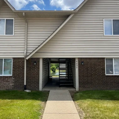 Exterior stairwell and siding area before renovation work by AY Remodeling & Restoration.