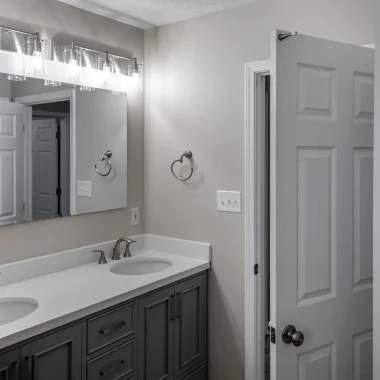 Updated bathroom with double vanity and modern finishes completed as part of a lake house addition by AY Remodeling & Restoration.
