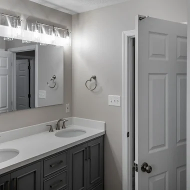 Updated bathroom with double vanity and modern finishes completed as part of a lake house addition by AY Remodeling & Restoration.
